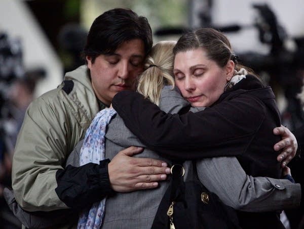 Crowd members hug after a verdict in the Noor trial 