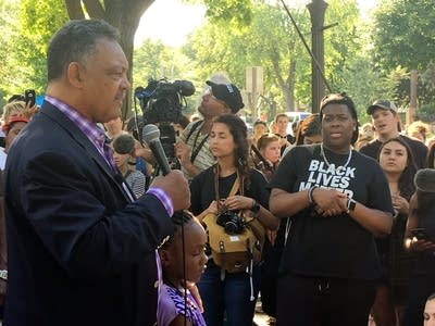 The Rev. Jesse Jackson speaks with protesters.
