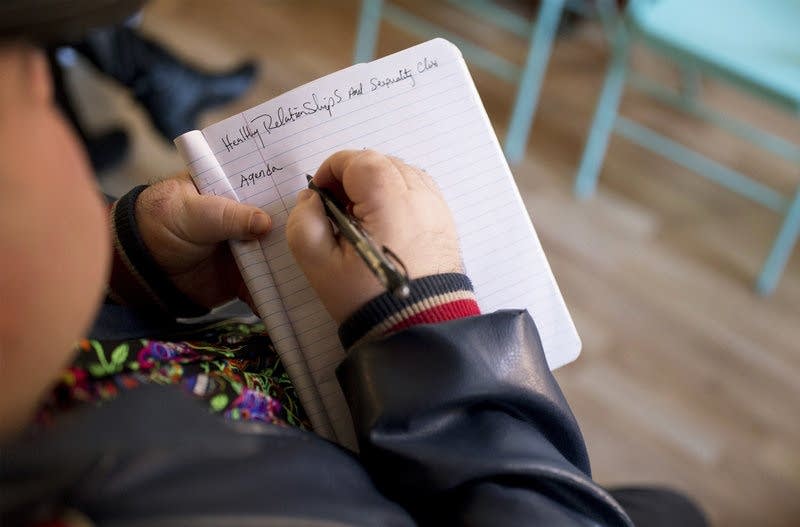 A student takes notes in Katy Park's Relate class.