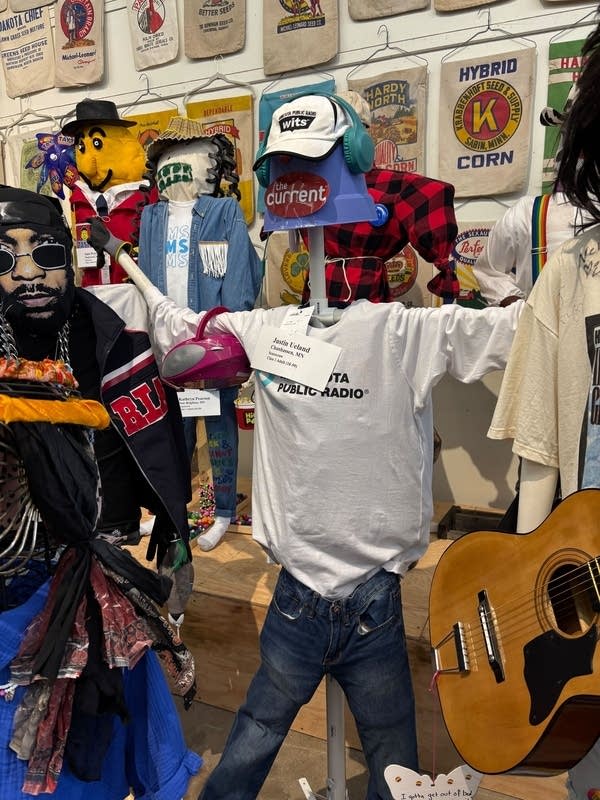 A homemade scarecrow is decked out in Minnesota Public Radio merchandise.