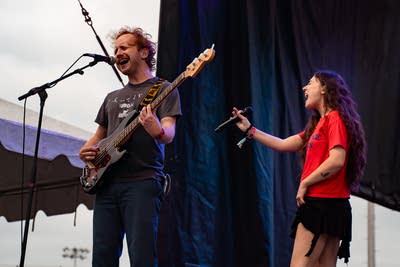 Samia performing on an outdoor stage.