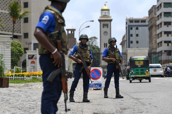 Soldiers take up their positions at a checkpoint on a street in Colombo.