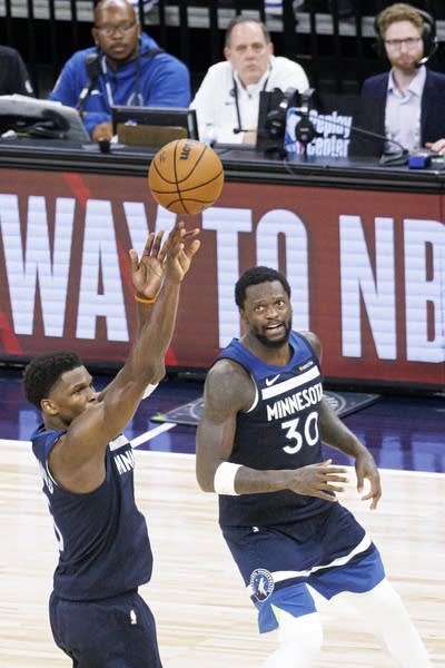 two men play basketball