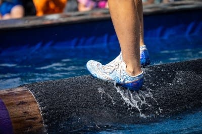 A close-up of a foot on a log