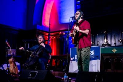 Two men performing inside church