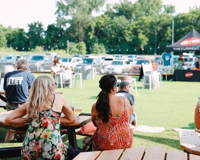 people enjoying live music and a happy hour outdoors