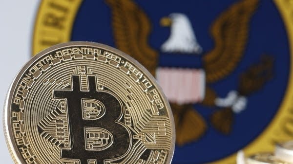 A gold bitcoin in front of the SEC emblem.