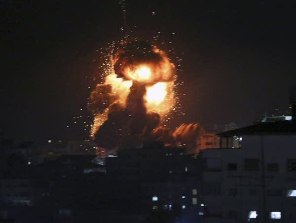An explosion caused by Israeli airstrikes is seen in Gaza City.