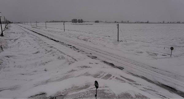 Light snow Sunday night; Moderating temperatures this week