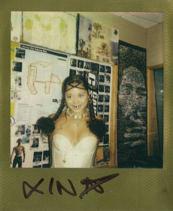 xina posing in a polaroid photo