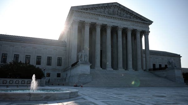 The sun rises behind the U.S. Supreme Court building on Aug. 27 — the day after the court blocked the latest eviction moratorium.