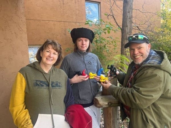 family poses with animal toys