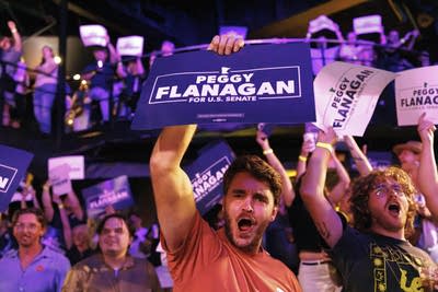 A crowd of supporters cheers for Peggy Flanagan.