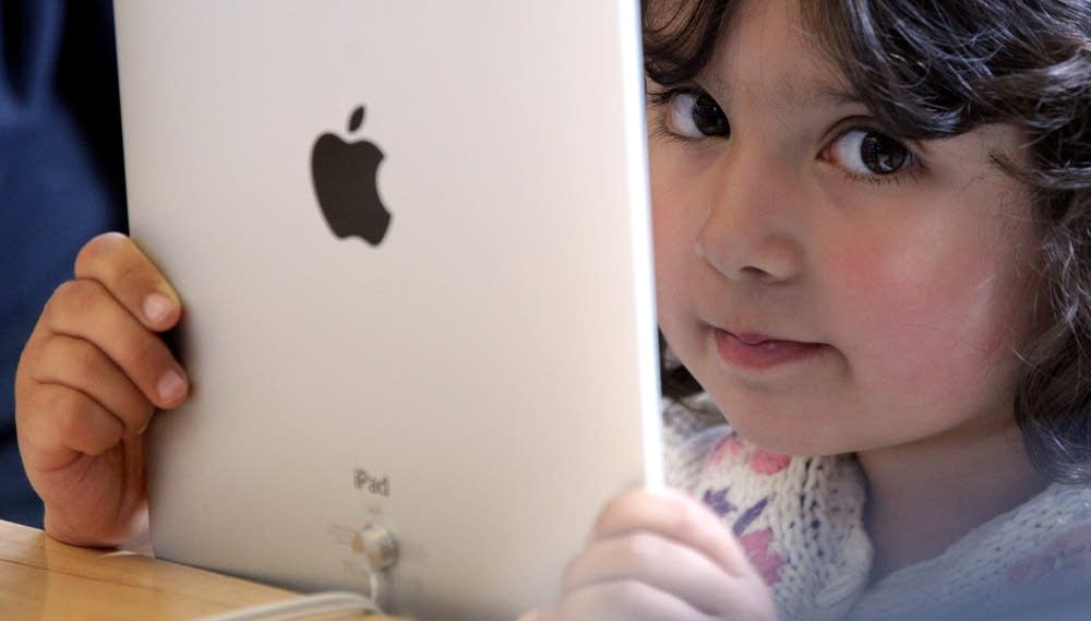 Young girl holds iPad