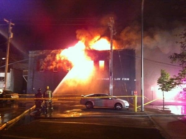 Winona firefighters train their hoses on one of the buildings burning downtown early Friday morning. (Photo courtesy Jerome Christenson/Winona Daily News)