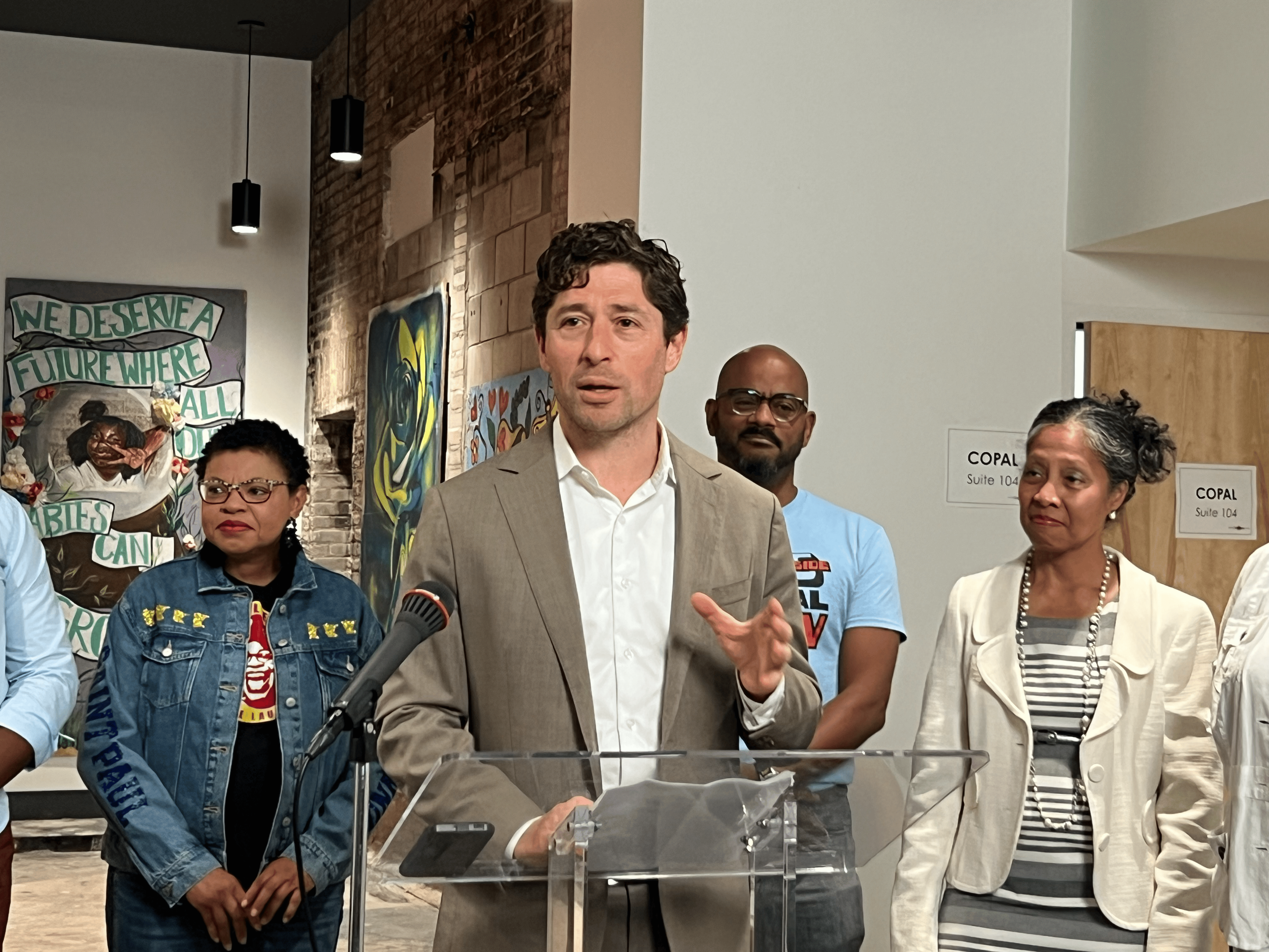 A man speaks at a podium