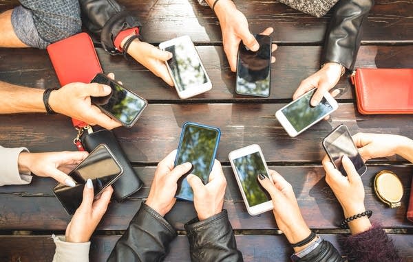 A group of people using smartphones