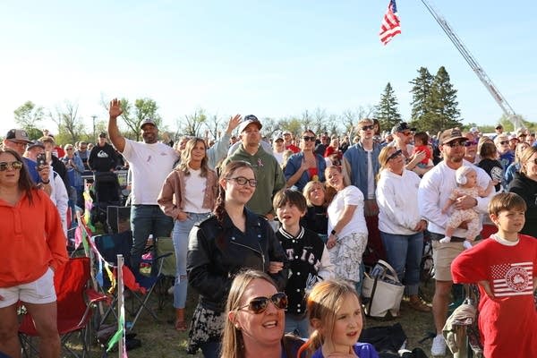 A large crowd watches a musical performance.