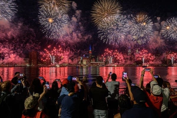 Spectators watch as fireworks explode