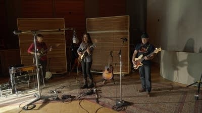 A band performing in a recording studio