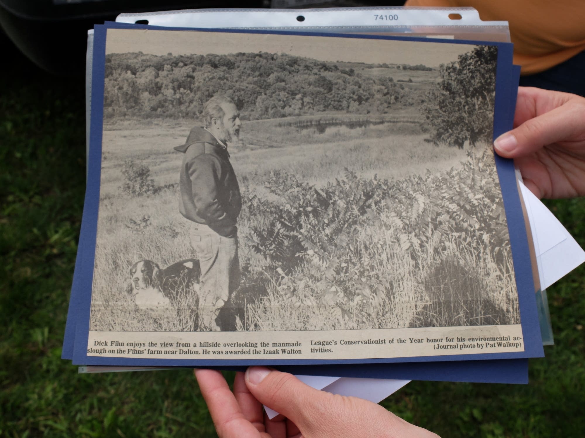 Loreli Westby holds a newspaper article about conservation efforts.
