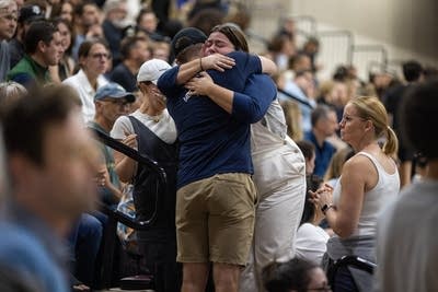 Two people embrace