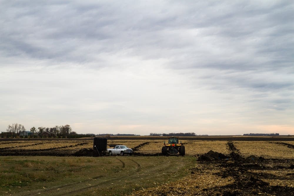 Installing tile drainage system on a farm.