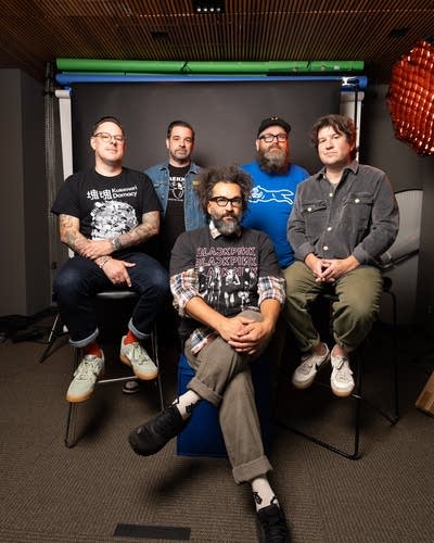 Five members of Motion City Soundtrack pose for a photo.