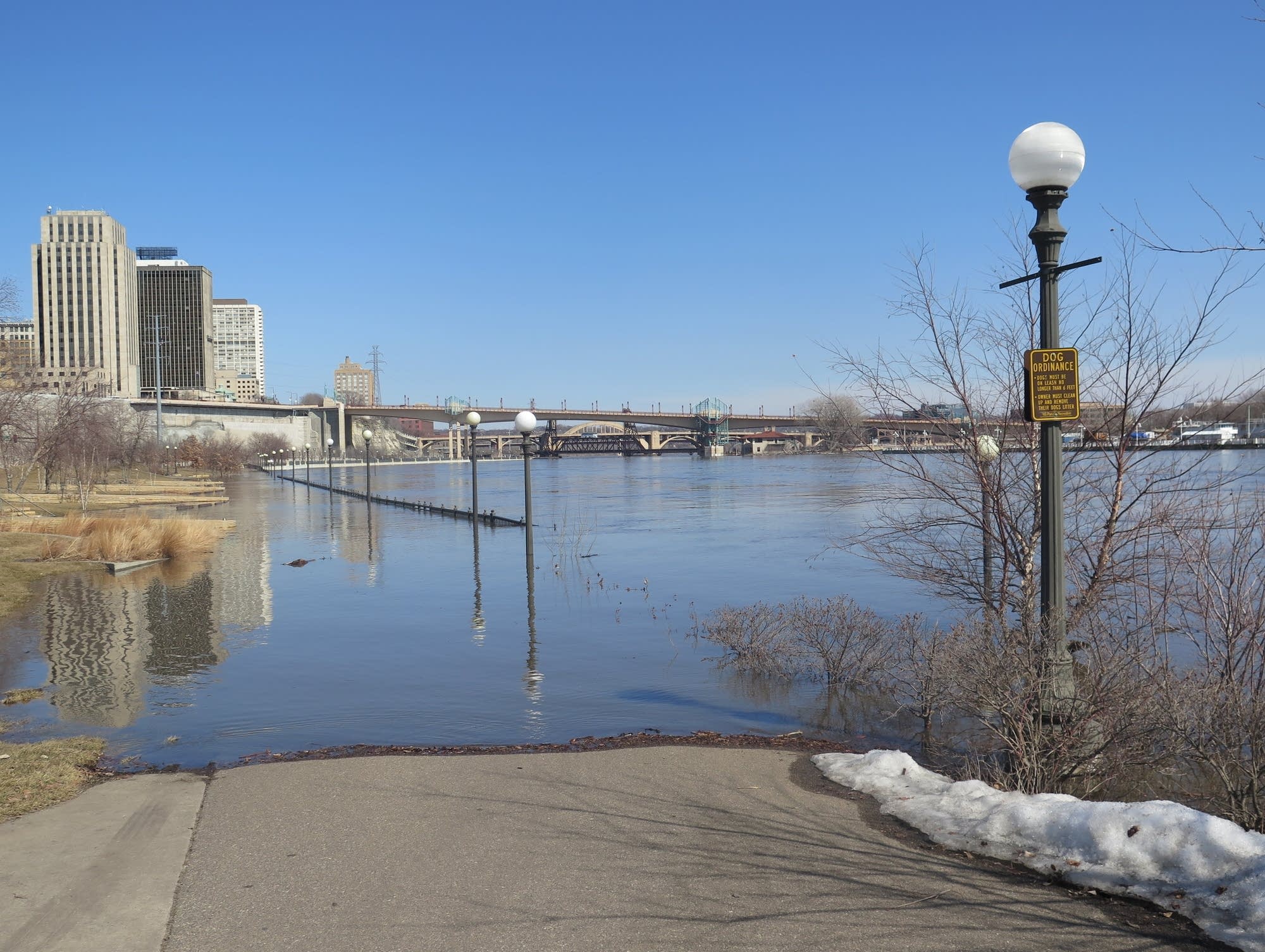 A flooded walkway along the banks of the Mississippi River in St. Paul.