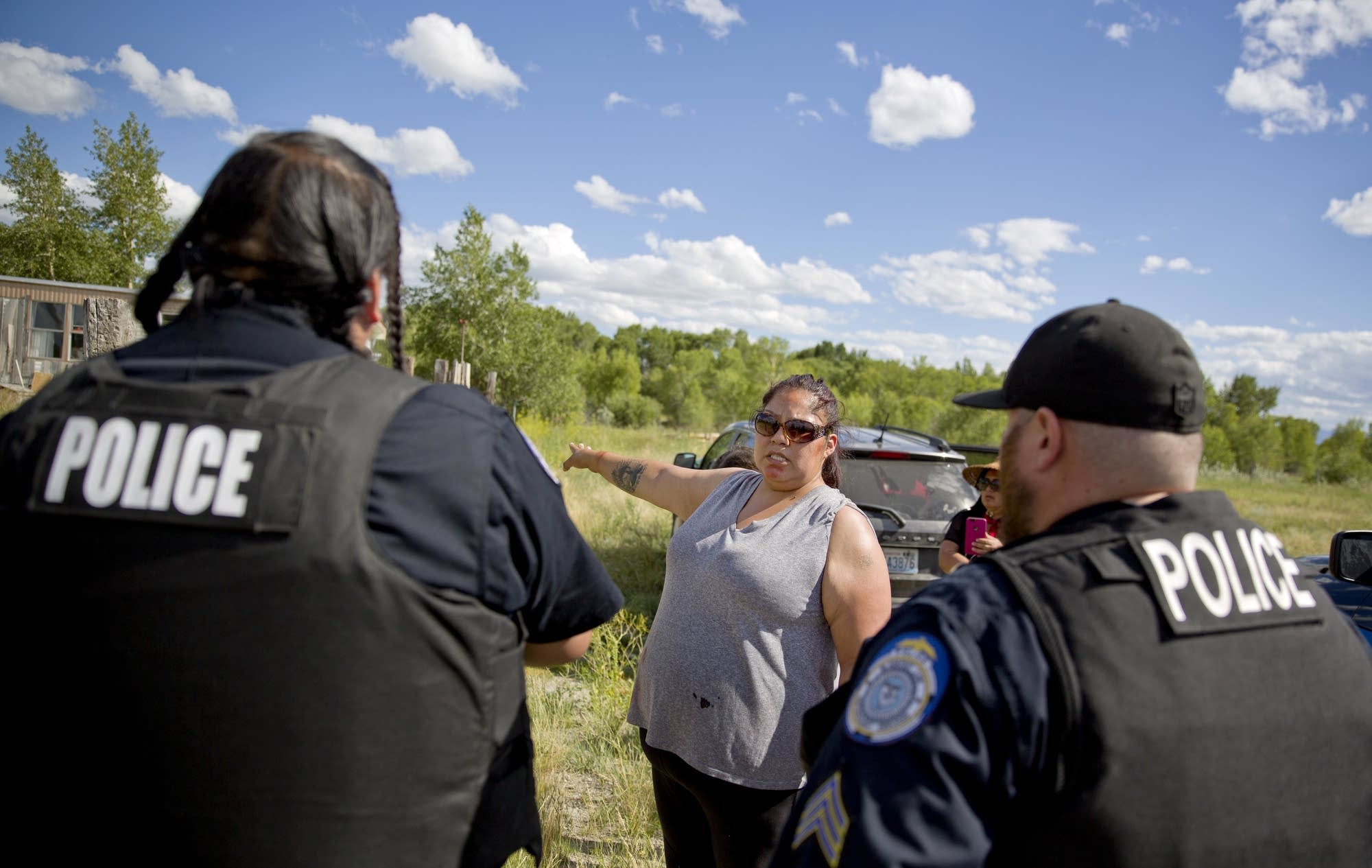 Lissa Loring points Blackfeet law enforcement officers to a trailer.