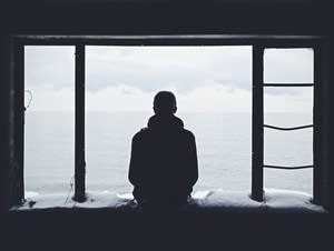 Man looking at a body of water.