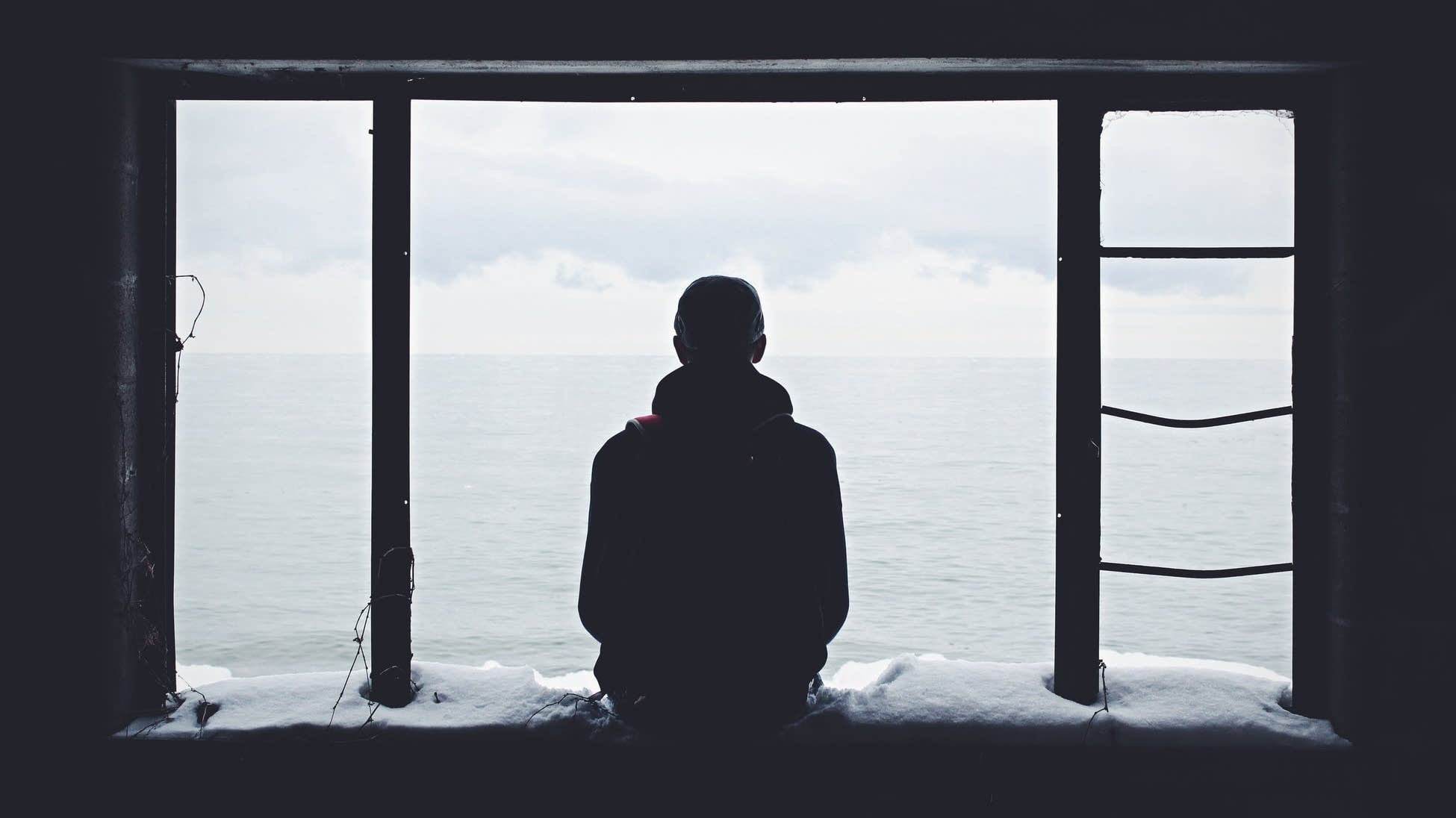 Man looking at a body of water.