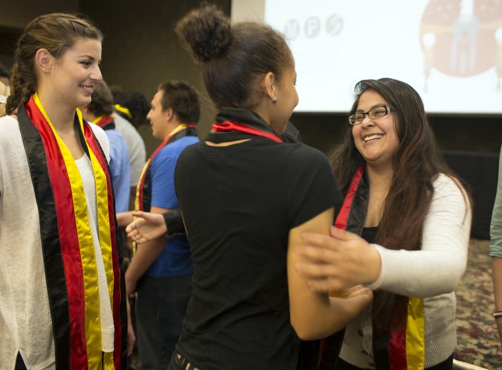 Students receive stoles to wear at graduation.