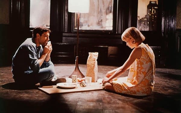 Scene from Rosemary's Baby with couple eating dinner on floor