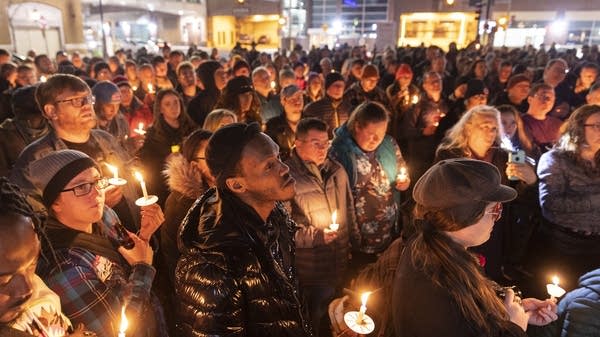 Community members gather for a candlelight vigil outside