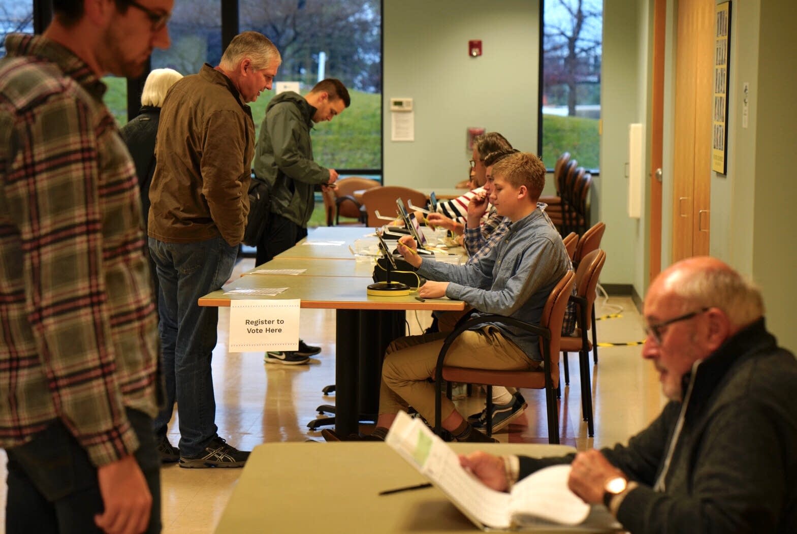 Student judge Mark Kivimaki checks in voters.