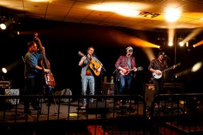A four-piece band performing onstage