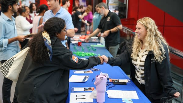 Dayton Gebeau (right) represented one of the 82 companies at CollegeFest, an annual career fair in Cleveland aimed at connecting students with potential employers.
