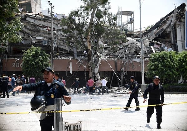 Mexicans dig through collapsed buildings as quake kills more than 200