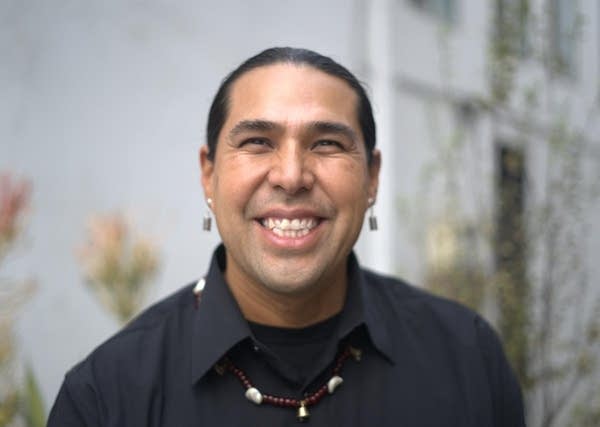 A person smiles for a photo