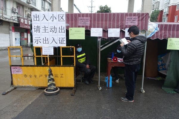 Checkpoints set up outside residential communities. Some districts require residents to register for an entry-exit pass as part of the new coronavirus prevention measures.
