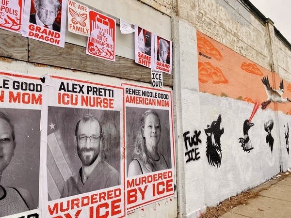 Signs show two photos of people in black and white.