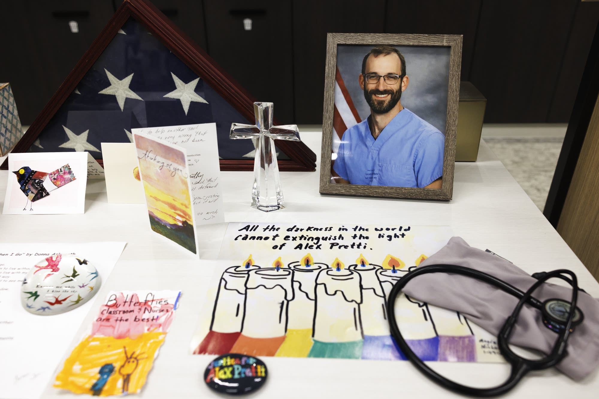 A memorial display honoring Alex Pretti, including a framed
