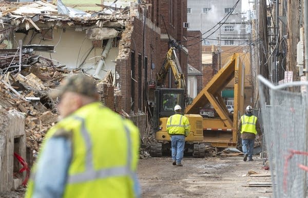 Demolition crew members inspect an area of the Northland Building.