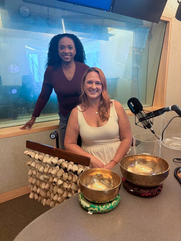 two women smiling in a broadcast studio