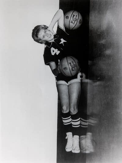 A woman poses with a basketball