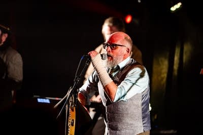 A musician sings onstage 