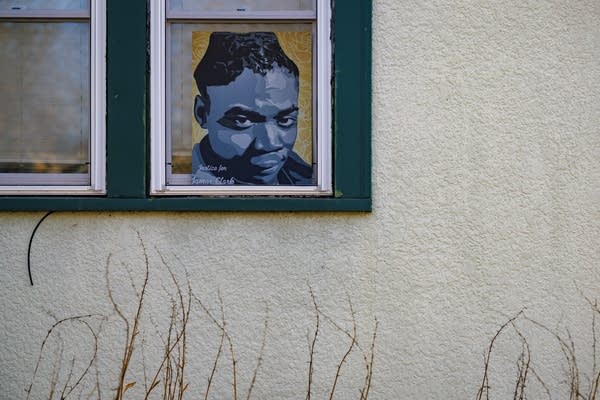 A portrait of Jamar Clark hangs