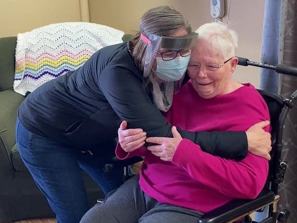 A woman hugs her mother