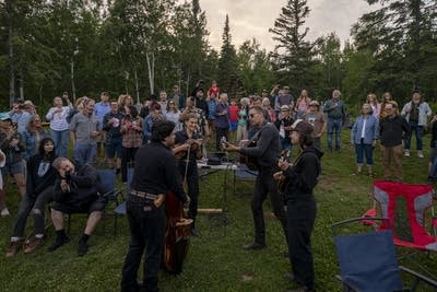 the band wild horses performing among a crowd of people